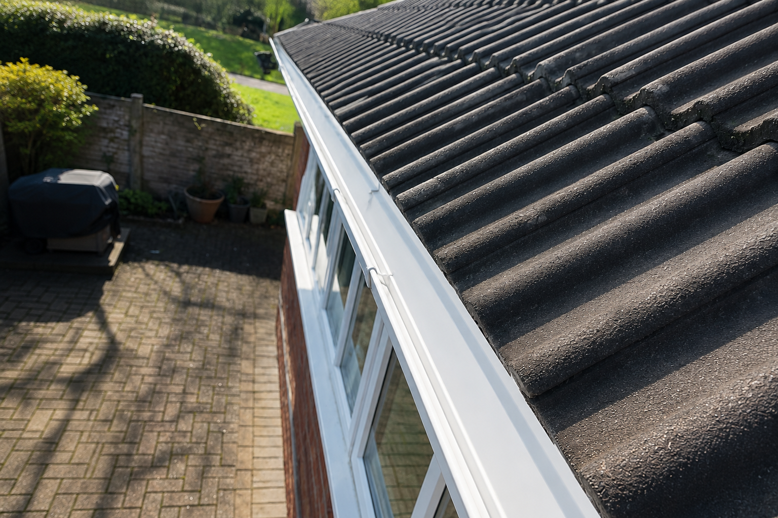 After professional gutter cleaning in Birmingham — clear white gutter channel fully restored